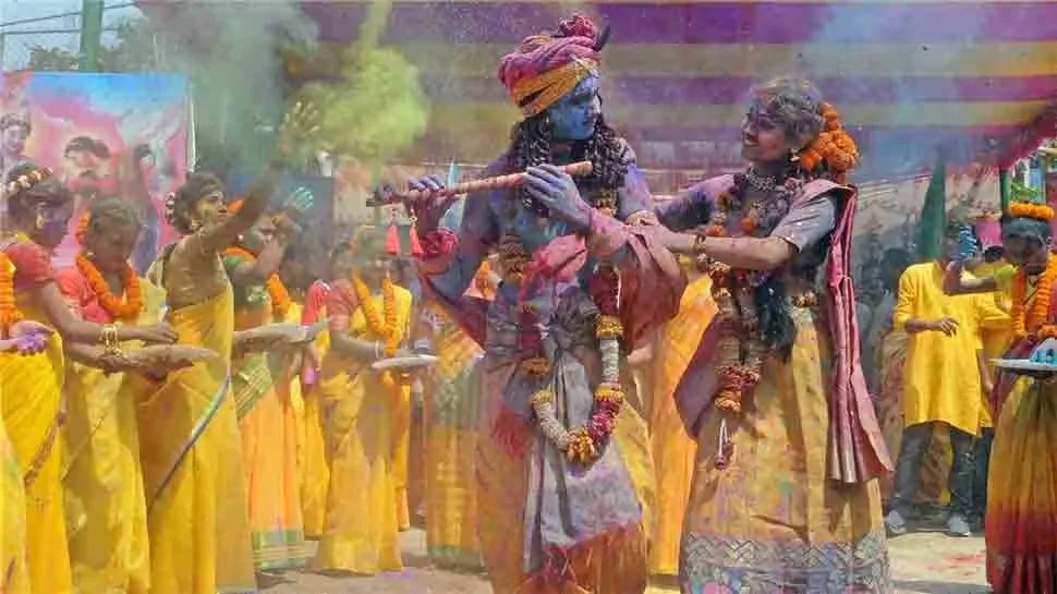 Crowds covered in coloured powder during Holi celebrations in Braj